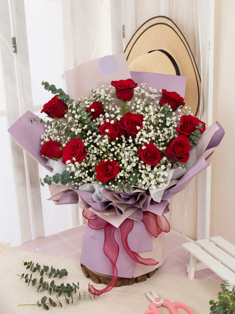 12 red roses bouquet with lush green foliage from OnlineFlowerDelivery.ae available for Flower delivery In Dubai
